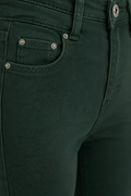 Push-up trousers that enhance the figure, in green and beige.